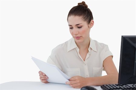 simsearch:400-04894274,k - Businesswoman looking a document against a white background Stock Photo - Budget Royalty-Free & Subscription, Code: 400-06627016