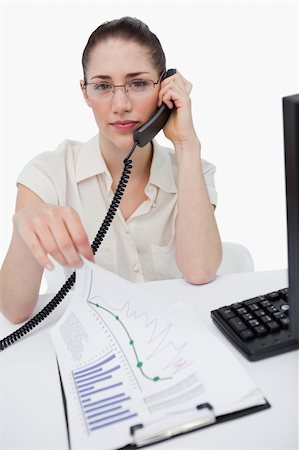 Portrait of a manager making a phone call while looking at statistics against a white background Foto de stock - Super Valor sin royalties y Suscripción, Código: 400-06627024