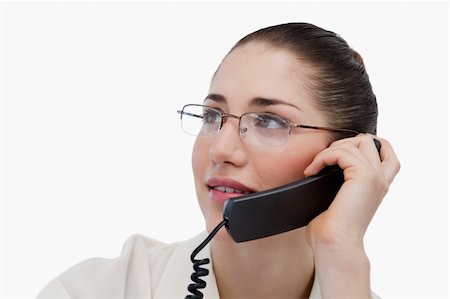 Close up of a secretary making a phone call against a white background Stock Photo - Budget Royalty-Free & Subscription, Code: 400-06627025