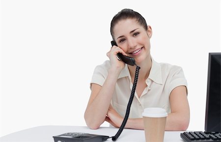 Smiling secretary answering the phone against a white background Stock Photo - Budget Royalty-Free & Subscription, Code: 400-06627020