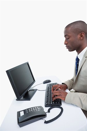 simsearch:400-04188055,k - Portrait of a businessman using a computer against a white background Stock Photo - Budget Royalty-Free & Subscription, Code: 400-06627034