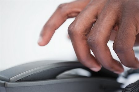 Close up of a masculine hand taking a phone handset against a white background Stock Photo - Budget Royalty-Free & Subscription, Code: 400-06627048