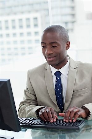 simsearch:400-04879813,k - Portrait of a happy office worker using a computer in his office Stock Photo - Budget Royalty-Free & Subscription, Code: 400-06627051