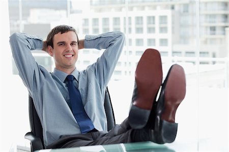 simsearch:400-05900668,k - Smiling manager relaxing in his office Stock Photo - Budget Royalty-Free & Subscription, Code: 400-06627066