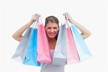 simsearch:400-06092781,k - Joyful woman holding shopping bags against a white background Photographie de stock - Aubaine LD & Abonnement, Code: 400-06627074