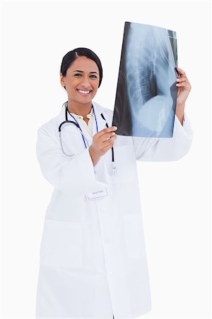 simsearch:400-06634198,k - Smiling female physician with x-ray against a white background Stock Photo - Budget Royalty-Free & Subscription, Code: 400-06634027