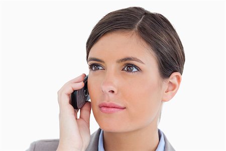 simsearch:400-06633122,k - Close up of female entrepreneur with her cellphone against a white background Stock Photo - Budget Royalty-Free & Subscription, Code: 400-06634038