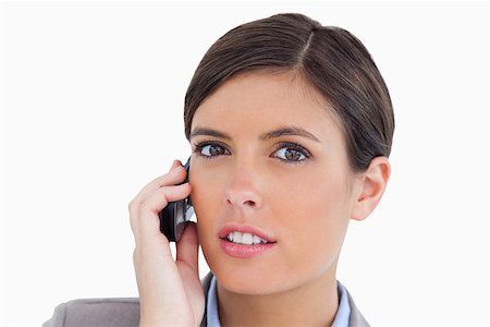 simsearch:400-06633122,k - Close up of female entrepreneur talking on her cellphone against a white background Stock Photo - Budget Royalty-Free & Subscription, Code: 400-06634039