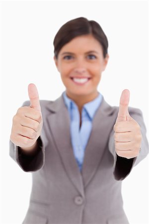 simsearch:400-05898224,k - Close up of thumbs up given by female entrepreneur against a white background Foto de stock - Royalty-Free Super Valor e Assinatura, Número: 400-06634032