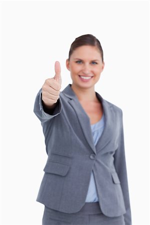 simsearch:400-05898224,k - Thumb up given by smiling saleswoman against a white background Foto de stock - Royalty-Free Super Valor e Assinatura, Número: 400-06634065