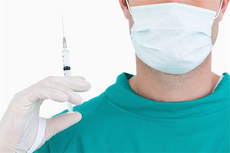 Close up of doctor with syringe wearing scrubs against a white background Stock Photo - Budget Royalty-Free & Subscription, Code: 400-06634094