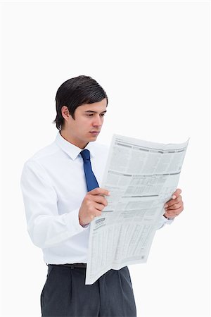 Young tradesman reading the news against a white background Stock Photo - Budget Royalty-Free & Subscription, Code: 400-06634143
