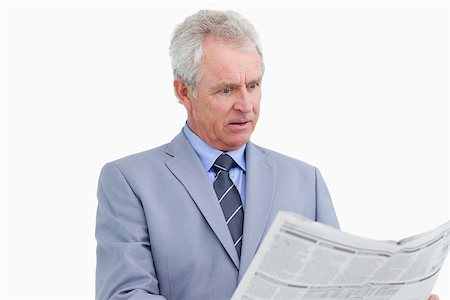 Mature tradesman surprised by the news paper against a white background Stock Photo - Budget Royalty-Free & Subscription, Code: 400-06634322