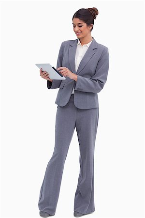 sales person with a tablet - Smiling female entrepreneur working on her tablet computer against a white background Photographie de stock - Aubaine LD & Abonnement, Code: 400-06634352