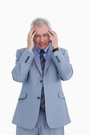 Mature tradesman having a headache against a white background Stock Photo - Budget Royalty-Free & Subscription, Code: 400-06634383