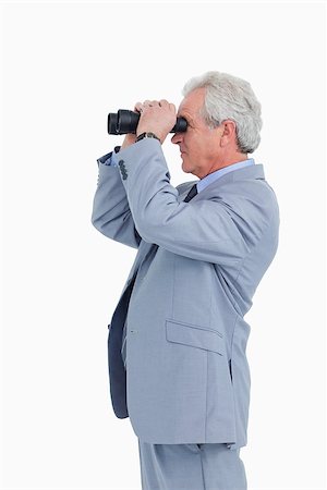 Side view of mature tradesman looking through spy glass against a white background Stock Photo - Budget Royalty-Free & Subscription, Code: 400-06634392