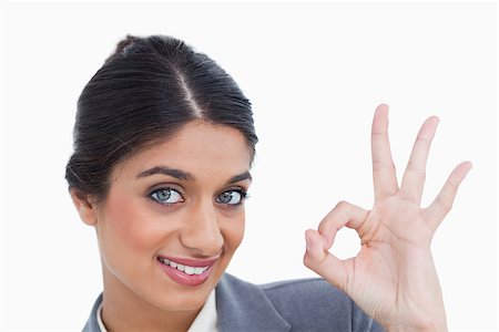 simsearch:400-05898224,k - Close up of smiling female entrepreneur giving her approval against a white background Foto de stock - Royalty-Free Super Valor e Assinatura, Número: 400-06634438