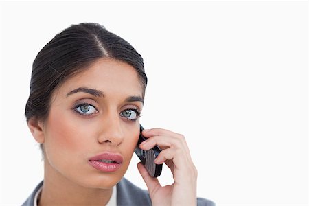 simsearch:400-06633122,k - Close up of female entrepreneur listening to caller against a white background Stock Photo - Budget Royalty-Free & Subscription, Code: 400-06634439