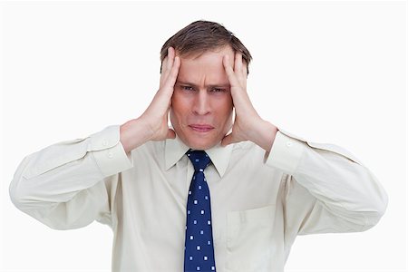 Close up of businessman experiencing a headache against a white background Stock Photo - Budget Royalty-Free & Subscription, Code: 400-06634458