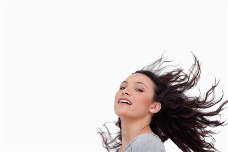 Young woman with her hair in motion against a white background Stock Photo - Budget Royalty-Free & Subscription, Code: 400-06634491