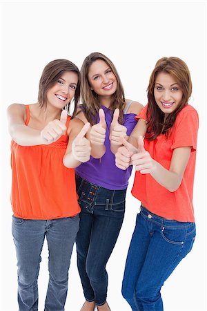 simsearch:400-06634629,k - Happy teenagers putting their thumbs up Fotografie stock - Microstock e Abbonamento, Codice: 400-06634588