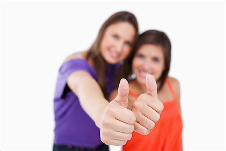 simsearch:400-06634629,k - Thumbs up being showed by teenagers standing next to each other with focus on their thumbs Fotografie stock - Microstock e Abbonamento, Codice: 400-06634628