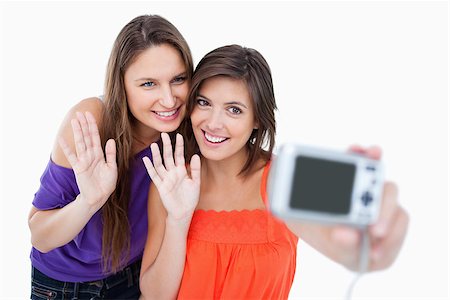 simsearch:400-06634629,k - Teenagers waving in front of a digital camera Fotografie stock - Microstock e Abbonamento, Codice: 400-06634631