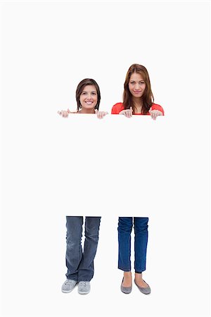 Smiling teenagers proudly holding a blank poster against a white background Stock Photo - Budget Royalty-Free & Subscription, Code: 400-06634644