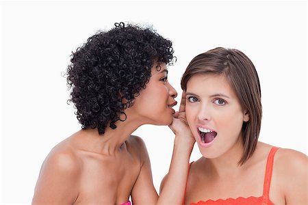 simsearch:400-06634629,k - Attractive teenage whispering a surprising secret to a friend Fotografie stock - Microstock e Abbonamento, Codice: 400-06634666