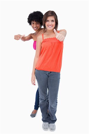 simsearch:400-06634629,k - Happy teenagers showing their thumbs on the side in enjoyment Fotografie stock - Microstock e Abbonamento, Codice: 400-06634662