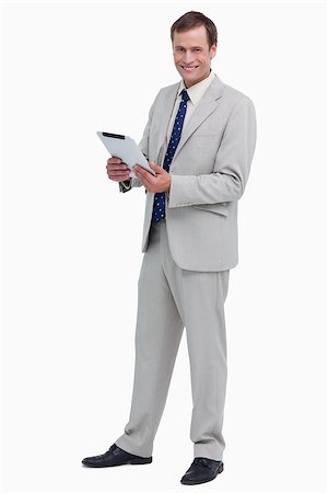 sales person with a tablet - Smiling businessman with his tablet computer against a white background Photographie de stock - Aubaine LD & Abonnement, Code: 400-06634718