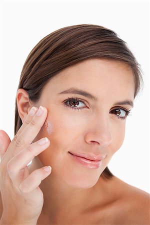 Beautiful teenager applying moisturizer cream on her face with her fingers Stock Photo - Budget Royalty-Free & Subscription, Code: 400-06634724