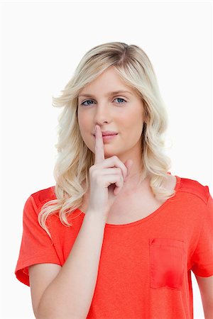 Attractive young woman looking at the camera while telling to shut up Stock Photo - Budget Royalty-Free & Subscription, Code: 400-06634762