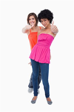 simsearch:400-06634629,k - Teenagers showing thumbs up one behind the other against a white background Fotografie stock - Microstock e Abbonamento, Codice: 400-06634885