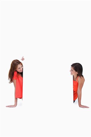 simsearch:400-06634629,k - Teenagers smiling and looking at each other in front of a blank poster Fotografie stock - Microstock e Abbonamento, Codice: 400-06634881