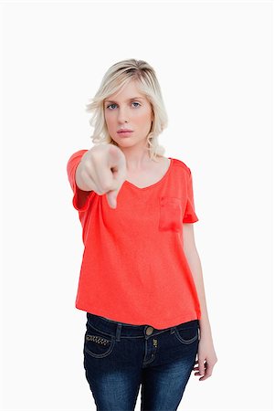 simsearch:400-06635276,k - Serious blonde woman pointing her finger against a white background Photographie de stock - Aubaine LD & Abonnement, Code: 400-06634962