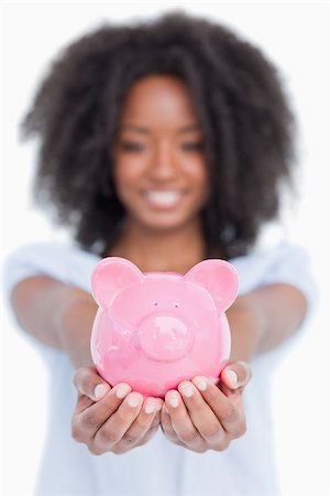 piggy bank hand - Piggy bank held by a woman in front of the camera and against a white background Stock Photo - Budget Royalty-Free & Subscription, Code: 400-06634983