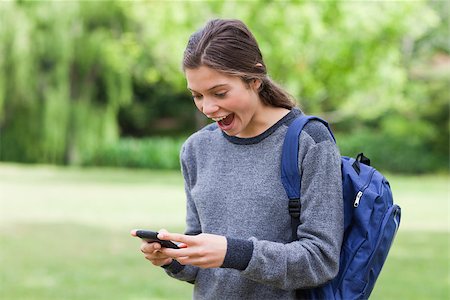 Young cute girl showing her surprise after receiving a text on her mobile phone Stock Photo - Budget Royalty-Free & Subscription, Code: 400-06635322