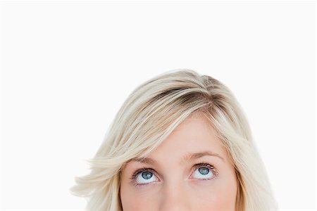 face female mystery - Upper part of the face of a blonde woman looking up against a white background Stock Photo - Budget Royalty-Free & Subscription, Code: 400-06635356