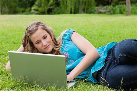 student college laptop lying grass - Calm student lying on the grass with her hand on head while working with her laptop Stock Photo - Budget Royalty-Free & Subscription, Code: 400-06635403