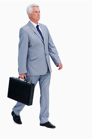 Businessman with a suitcase walking against white babckground Stock Photo - Budget Royalty-Free & Subscription, Code: 400-06636506