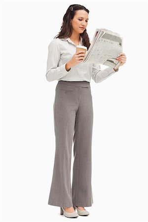 Employee reading the news with a coffee in the hand against white background Stock Photo - Budget Royalty-Free & Subscription, Code: 400-06636576