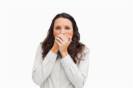 Portrait of a brunette with her hands on the mouth against white background Stock Photo - Budget Royalty-Free & Subscription, Code: 400-06636599