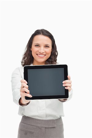 Portrait of a brunette showing a touchpad screen against white background Stock Photo - Budget Royalty-Free & Subscription, Code: 400-06636659