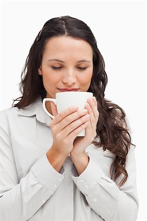 smell chocolate - Brunette smelling a tea against white background Stock Photo - Budget Royalty-Free & Subscription, Code: 400-06636675