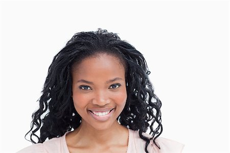 simsearch:400-06636885,k - A head shot of a young woman who is smiling against a white background Photographie de stock - Aubaine LD & Abonnement, Code: 400-06636864