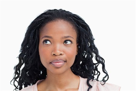 simsearch:400-06636885,k - A head shot of a young woman who is looking away from the camera against a white background Photographie de stock - Aubaine LD & Abonnement, Code: 400-06636869