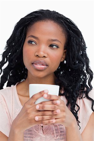 simsearch:400-06636885,k - A close up of a young woman holding a cup with her both hands Photographie de stock - Aubaine LD & Abonnement, Code: 400-06636876