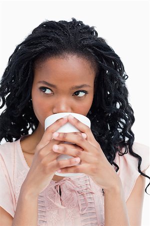 simsearch:400-06636885,k - A close up shot of a woman who is drinking out of a cup Photographie de stock - Aubaine LD & Abonnement, Code: 400-06636877