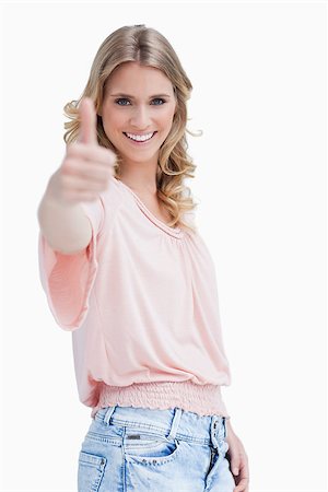 simsearch:400-06636885,k - A blonde woman with her thumb held up is smiling at the camera Photographie de stock - Aubaine LD & Abonnement, Code: 400-06637072